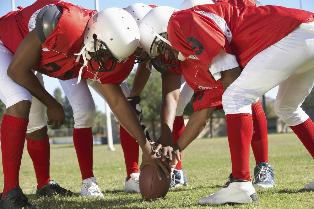 a picture of football players starting a game