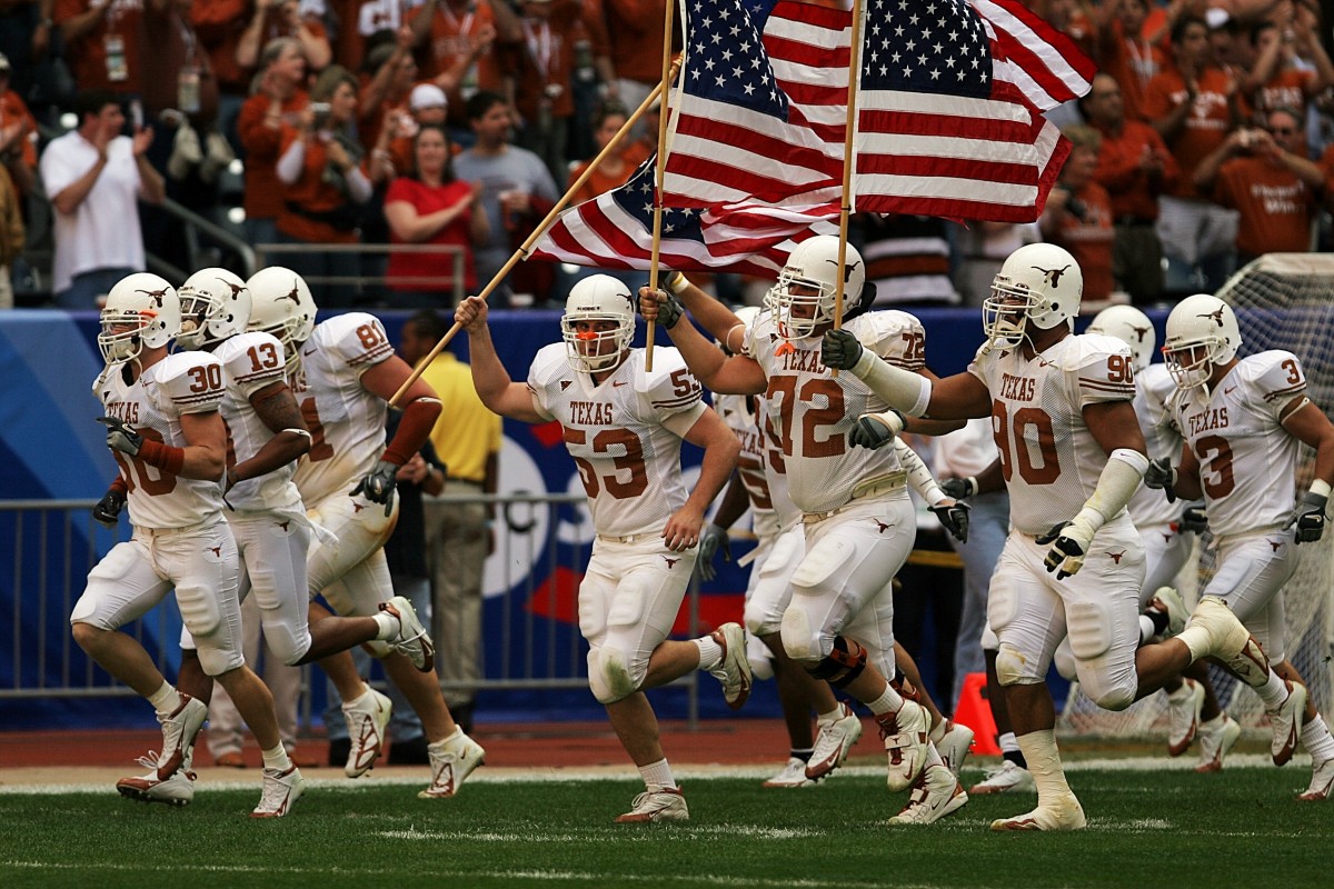 a Picture of American football players holding an American flag