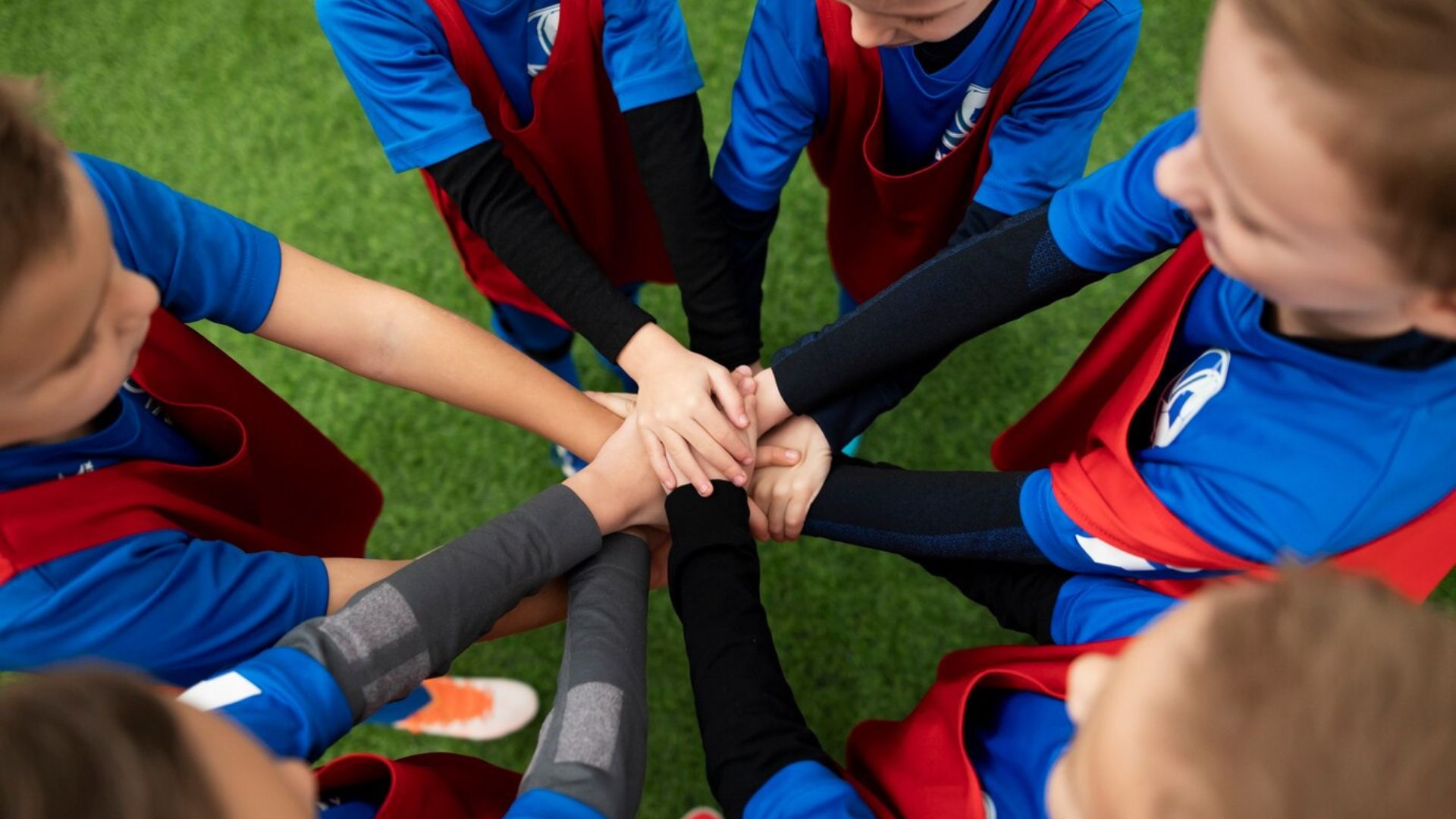 close up photo of kids putting hands together